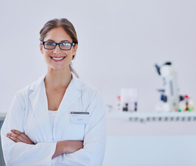 Fototapeta premium Crossed arms, woman and portrait of scientist in laboratory with confidence, smile and pride. Happy, professional and female virus researcher with skill for pharmaceutical and medical innovation.