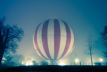 Hot air balloon on the ground in heavy fog