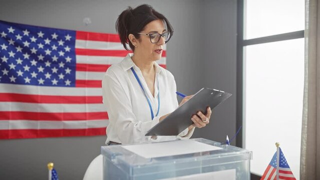 Mature hispanic woman taking notes in front of american flag indoors