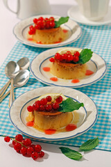 Lemon pudding with red currants.