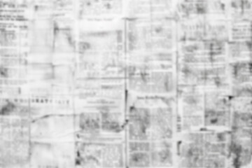 Blurred and worn newspaper texture in black and white, creating a vintage and aged effect. The image is suitable for backgrounds, design projects, and artistic themes.