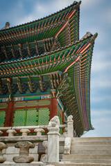 Low angle view of colorful patterned gyeongbokgung roof against sky