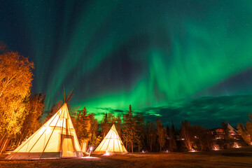 Amazing northern lights dancing over the light up Tipi or Tepees at Aurora Village in Yellowknife, Northwest Territories, Canada. © Shawn.ccf