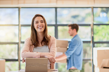 Woman, portrait and moving house with boxes, happy couple and real estate for new home or...