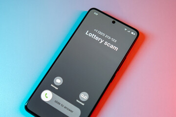 Lottery Scam call concept on mobile phone. Person get scam call alert. Phone call from unknown number late at night. Scam, fraud or phishing with smartphone concept. Prank caller, scammer or stranger
