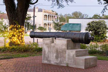 Natchez, Mississippi, USA - April 21, 2024: Twilight light descends on a civil war canon and quiet...