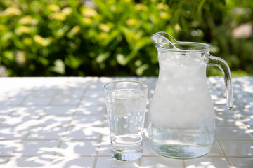 テラスで水分補給　木陰のテーブルで冷たいミネラルウォーターを飲む