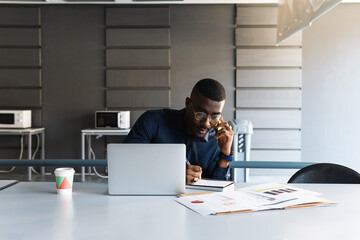 Phone call, notebook and computer black businessman at office planning, and writing success strategy for accounting company. South African corporate person work on 5g mobile smartphone, pc and notes