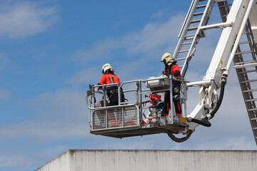 firefighters on a ladder in the middle of a rescue operation