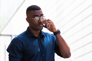 handsome african american businessman talking on mobile phone