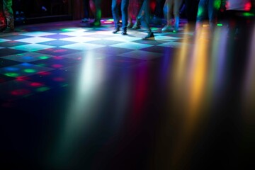 Disco in club. Dance floor in colored spots. Light music in club.