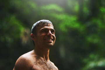 Happy man, jungle and wet from river in nature, wilderness and adventure in wild. Tropical land,...