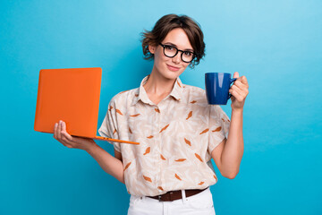 Portrait of successful pretty girl hold laptop fresh coffee mug isolated on blue color background - Powered by Adobe