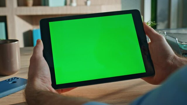 Company employee browsing chroma key tablet application at workplace close up. 