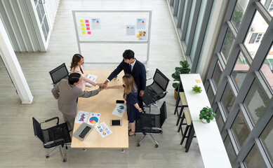 Business partners join hands in the modern office. Business executives team meeting business plan...