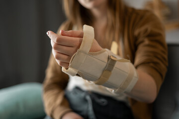 Broken wrist concept. Wrist to immobilize after injury. Woman uses arm splint. Inflammation of the...