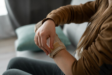 woman adjusts splint on her arm. Wrist fracture