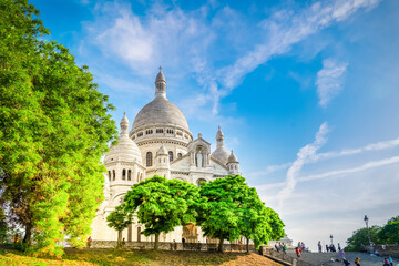 view of world famous Sacre Coeur church with summer trees, Paris, France, toned