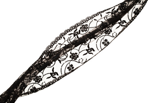 Black lace fabric flying in curve shape, Piece of textile black lace fabric throw fall in air. White background isolated, dark shading environment