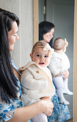 baby girl with mother at home