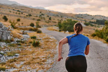 Empowered Runner Embracing Nature's Beauty on a Serene Morning Trail.