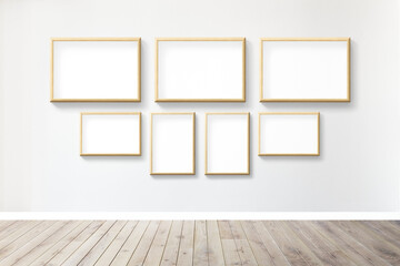 Wooden picture frame mockups hanging on a gray wall