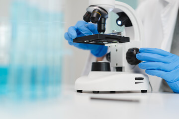 researcher using microscope analyse cell in medical lab.