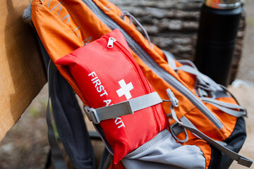 Naklejka premium Outdoor Adventure Backpack with an Essential First Aid Kit is great for hiking and camping. Ensure safety with this backpacks supplies for emergency situations in the wilderness