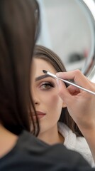 Satisfied Client Admiring New Lashes in Mirror During Beauty Salon Visit