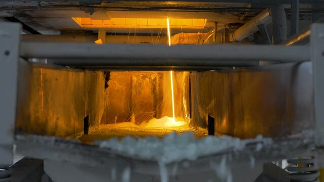 Production of ceramic frits glaze on heavy industrial enterprise. Minerals, pigments and fluxes melts during firing. Enterprise for the production of ceramic tiles