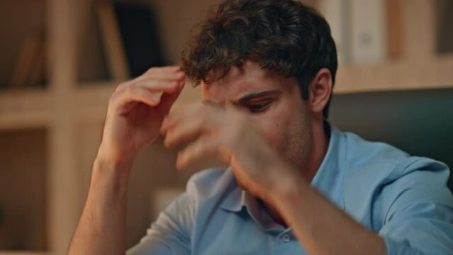 Aggressive businessman throwing papers on work desk late evening close up. 