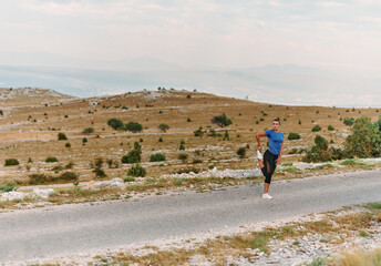 Determined Female Athlete Stretching After an Intense Run Through Rugged Mountain Terrain.