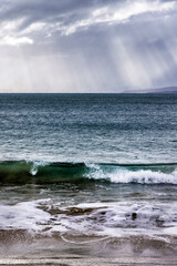 Fototapeta premium Sun rays at Clifton Beach, Tasmania, Australia