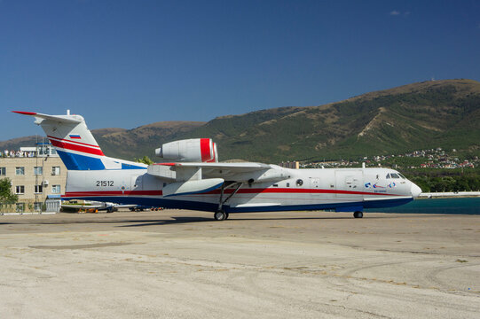 Hydroaviation salon 2010. Russian amphibious aircraft (flying boat) Be-200 Altair moves along concrete slabs towards sea. Close-up of airplane. Gelendzhik, Russia - September 12, 2010