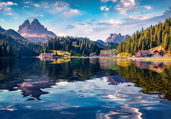 Huge mountain summit reflected in the calm waters of Misurina lake. Impressive summer view of...
