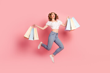 Full size photo of pretty woman dressed white blouse jeans holding shopping bags fly look empty...