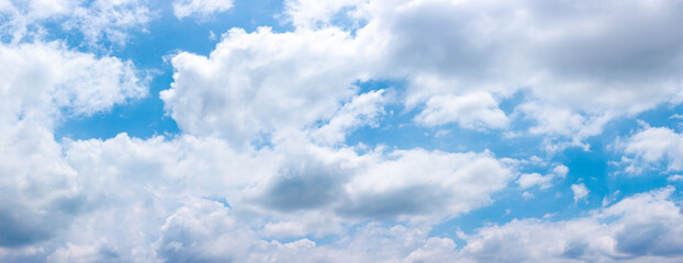 Blue sky background with colorful small clouds
