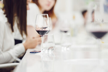  Wine glass poured with red wine on table during training. 