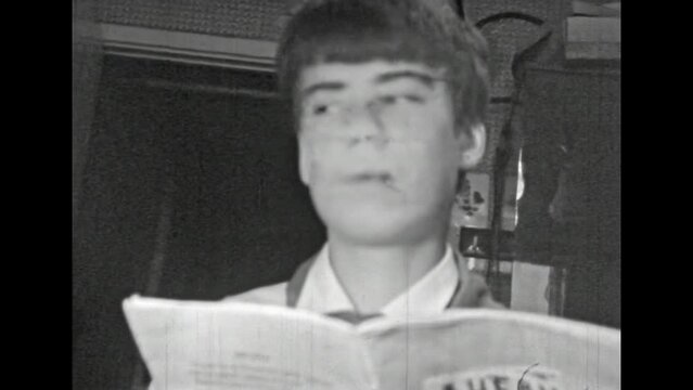 Teenage schoolboy worried about bad grade in school diary. Difficult adolescence in Soviet times. Pioneer schoolboy afraid of poor academic performance. Vintage black white film. Retro 1980s archive