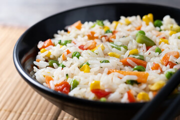 White fried rice with vegetables on wooden table