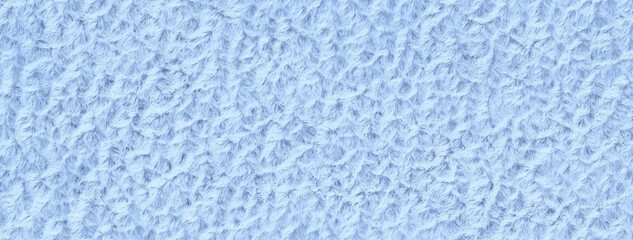 Light blue fluffy background of soft, fleecy cloth. Texture of sky textile backdrop with pattern, macro. Denim fabric