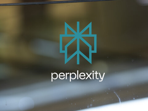 Perplexity AI logo on a window., Perplexity large language model perplexity.ai