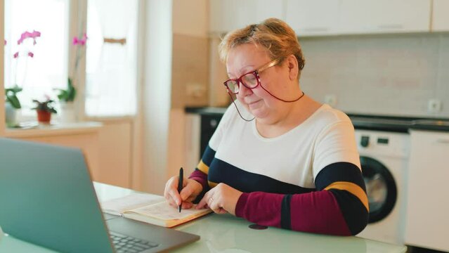 Discover the power of online education with a laptop and a notebook in hand