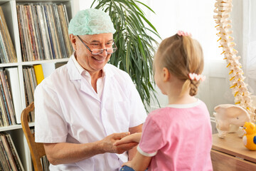 male doctor and young girl during medical examination, pediatric health, doctor visit, doctor...