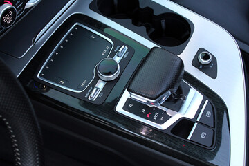 Selector automatic transmission with leather in the interior of a modern premium car. Gear shift lever for automatic transmission with Car control touchpad Panel.