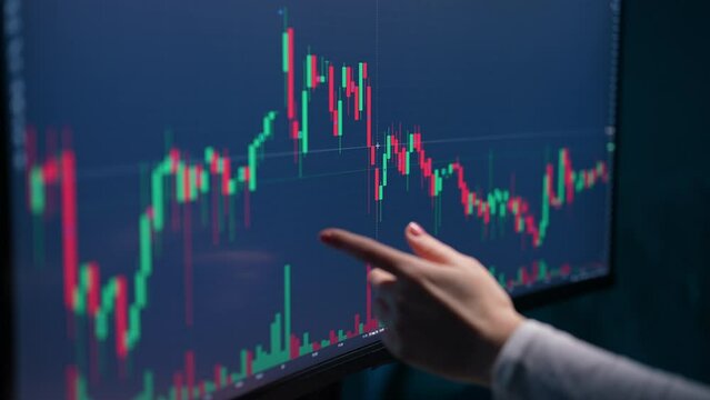 Closeup hand of pensive female trader analyzing graphs and charts stock market on computer screen. Unrecognizable woman investor thinking analyzing digital data. Concept of investing money on share.
