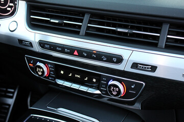Premium car climate control. Close-up detail with the air conditioning panel inside a Lux car....