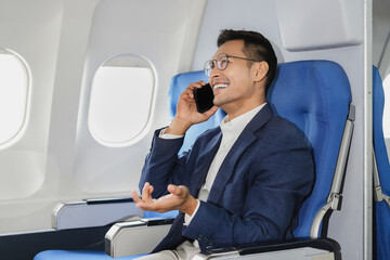 Airplane, travel and portrait of businessman working on laptop computer and smartphone while sitting in airplane.