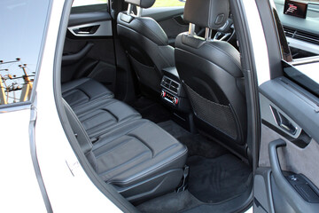 Leather back passenger seats in modern luxury car. Comfortable leather seats. Mid-Size SUV rear seats. Premium SUV interior. Car inside.