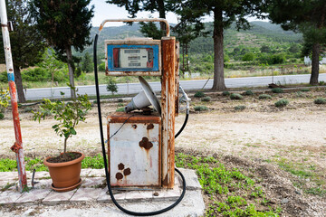 An old and abandoned gas pump at a gas station.